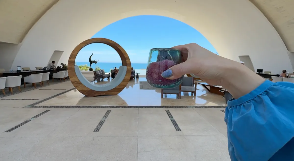 Jasmine and George with their first drinks at Marquis Los Cabos, a Midori sour and piña colada poolside
